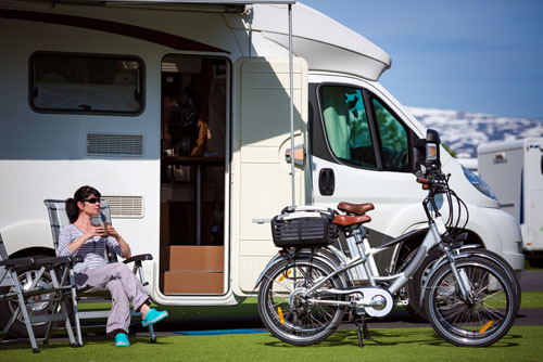 relaxing outside by an RV and bicycles
