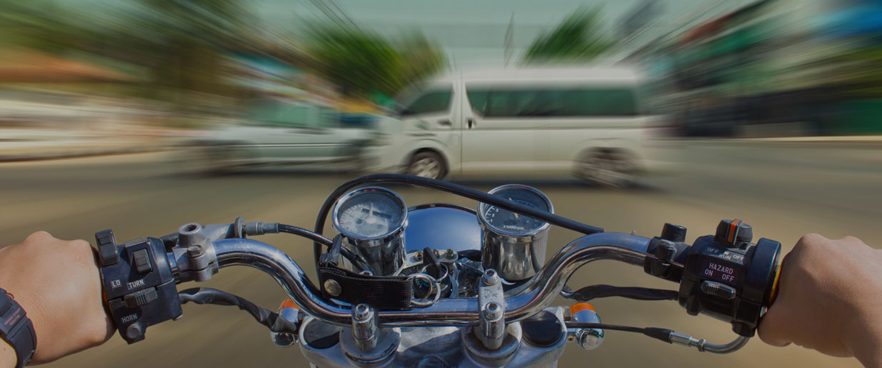 dramatic picture of motorcycle speeding towards a van